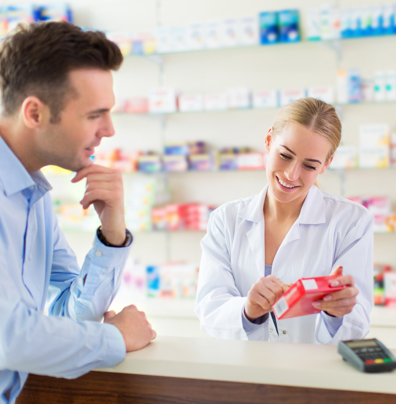 pharmacist explaining prescription to customer